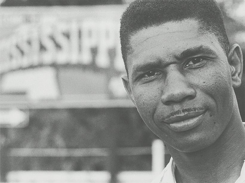 Close up black and white portrait of a black man with a thin mustache