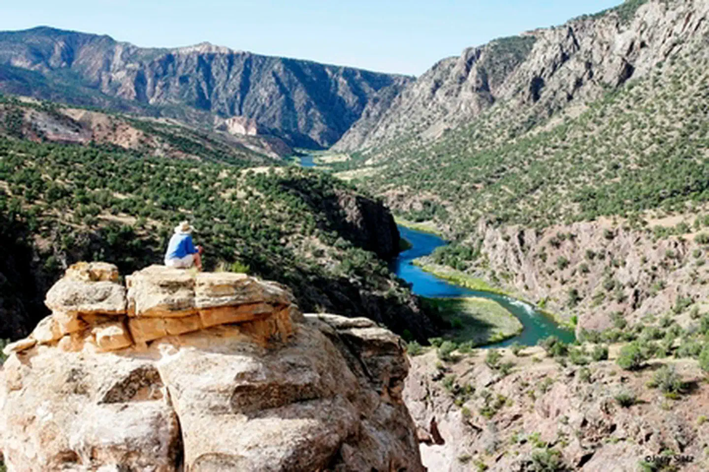 Hiker overlooking Gunnison River within Gunnison Gorge Wilderness